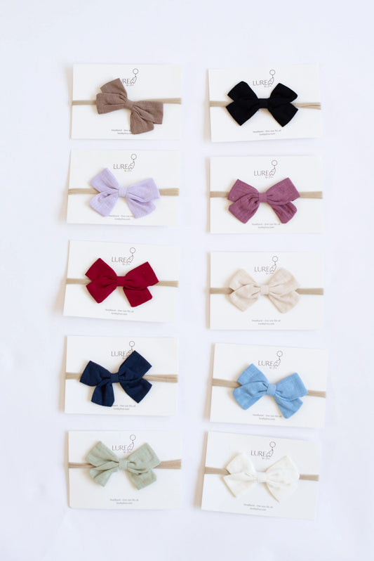 newborn wearing baby bow headband