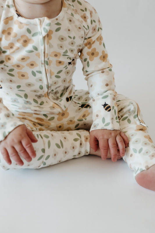 Baby girl wearing LURE by Lina Diaper Peek-a-Boo sleeper — soft cotton blend floral print - zippier with mittens and convertible feet