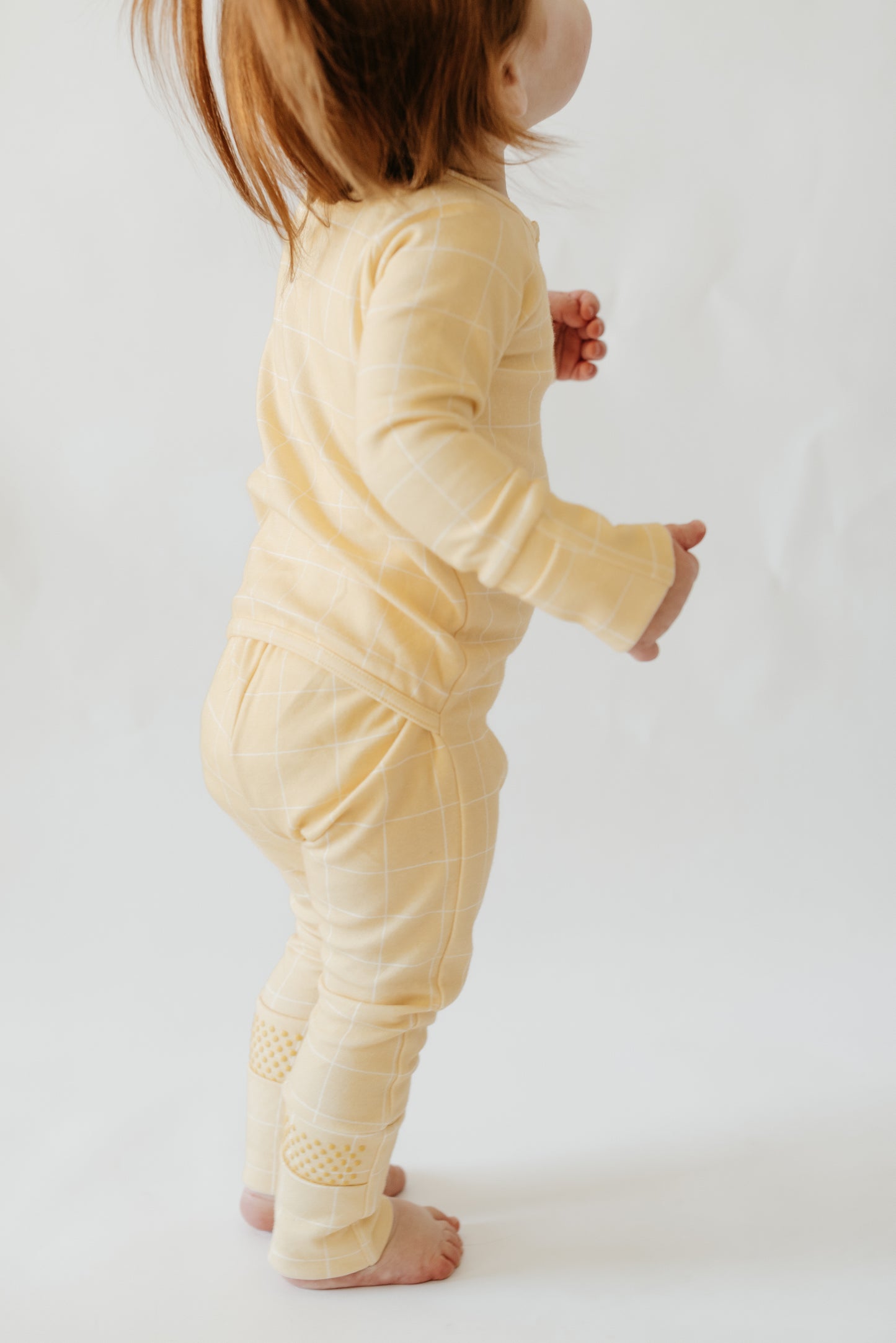 Flat lay of LURE by Lina Diaper Peek-a-Boo sleeper — breathable cotton baby sleepwear with two-way zipper and OEKO-TEX® certified fabric