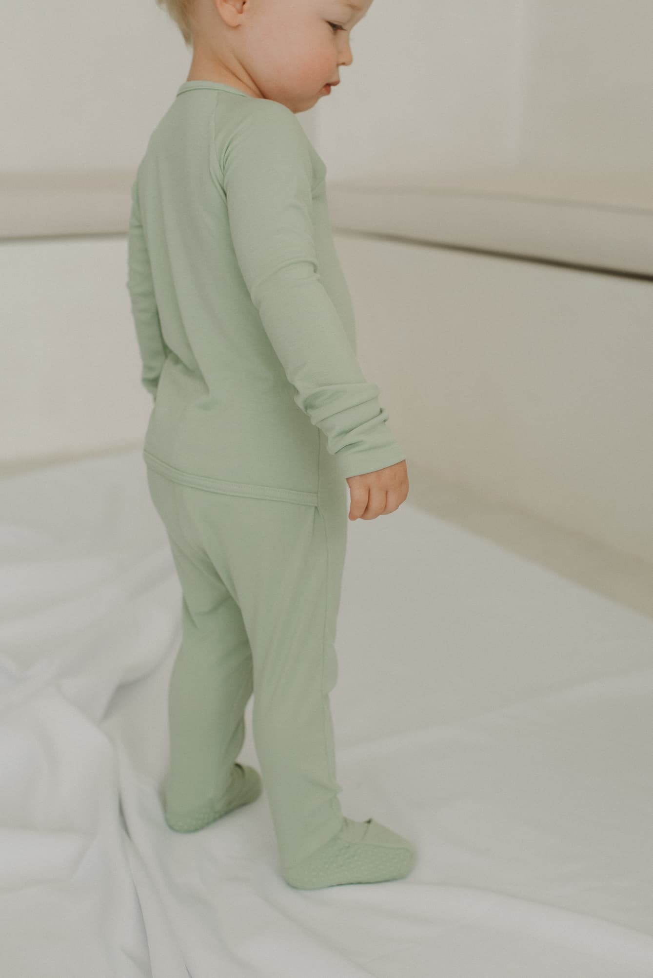 LURE by Lina — Essentials baby sleepwear in Pistachio - neutral color —calm solid, Diaper Peek-a-Boo, convertible hands and feet.