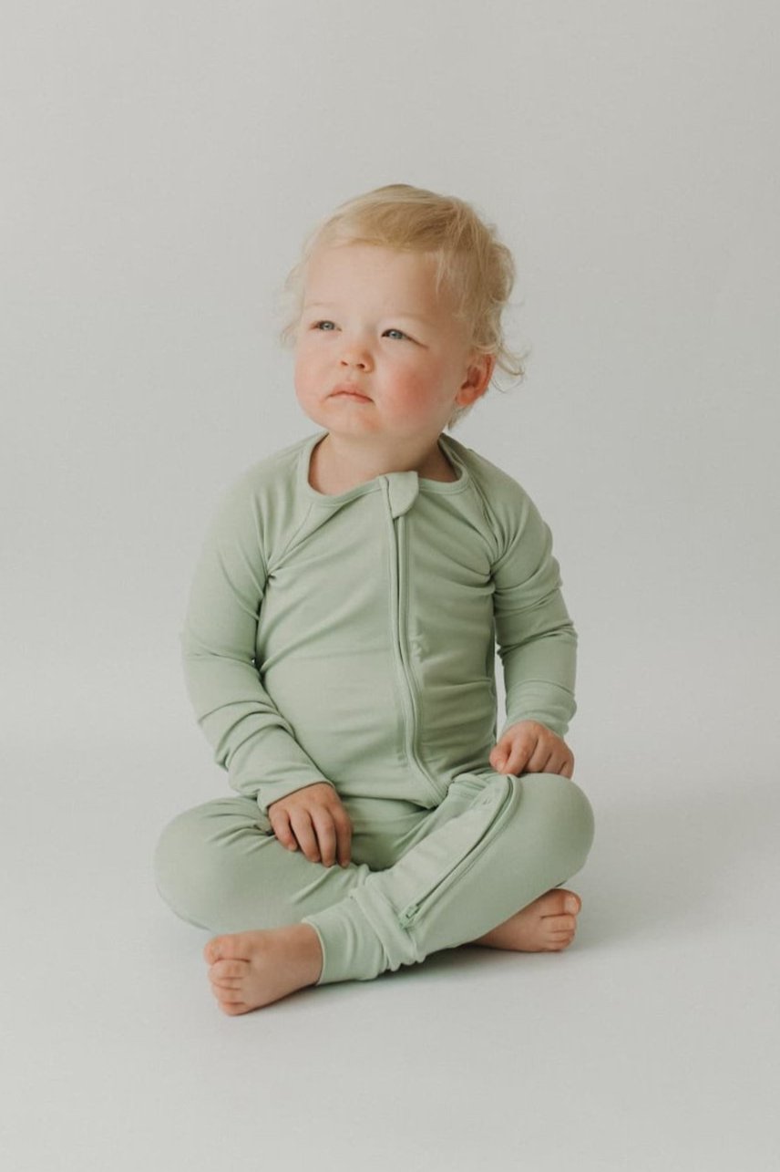 Pistachio Essentials zip footie—two-way zipper with a fabric guard to protect baby’s skin; smooth, stretchy fabric that holds its shape and stays breathable for all-night comfort.