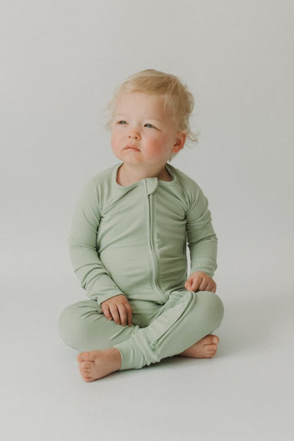 Pistachio Essentials zip footie—two-way zipper with a fabric guard to protect baby’s skin; smooth, stretchy fabric that holds its shape and stays breathable for all-night comfort.