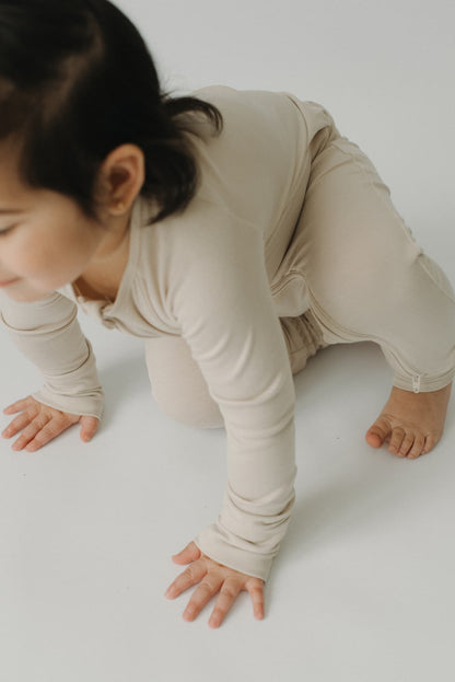LURE by Lina — Essentials baby zip footie in Sandstone—neutral solid, Diaper Peek-a-Boo, convertible hands & feet