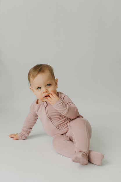 Bamboo baby girl pajamas with long sleeves, featuring convertible feet and dual zippers.