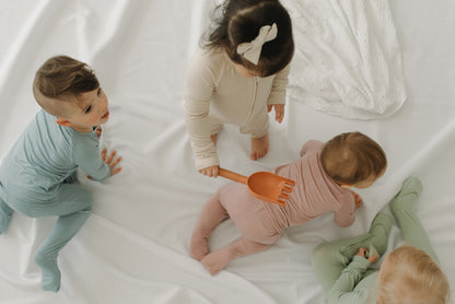 LURE by Lina — Essentials solids in Sandstone, Pink Paradise, Lilac, Steel Blue, Pistachio, Charcoal, Velvet—unisex solid neutral colors with two-way zipper and diaper-peek-a-boo feature