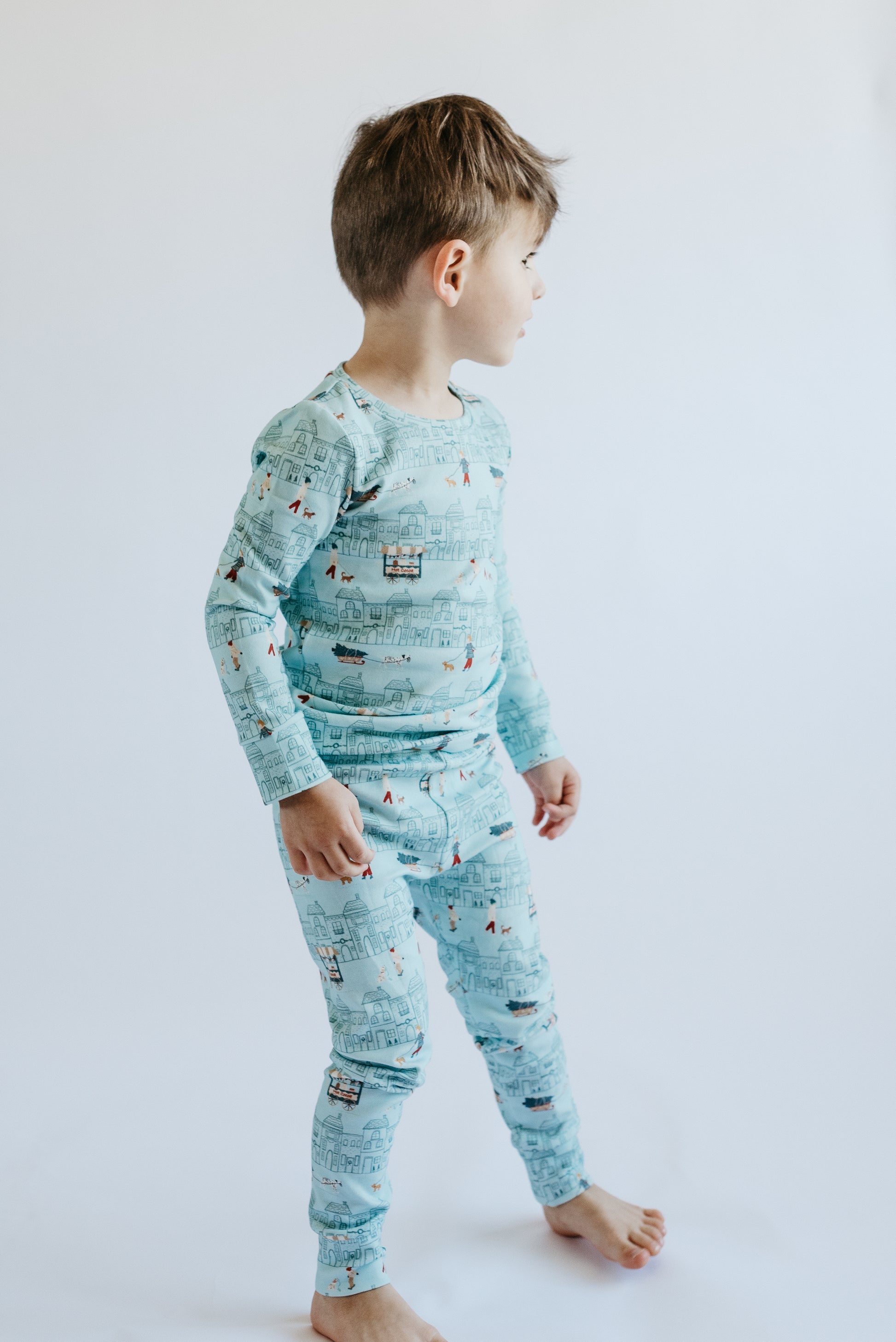 Merry Little Street print two-piece holiday PJs by LURE — long-sleeve top and pants, aqua