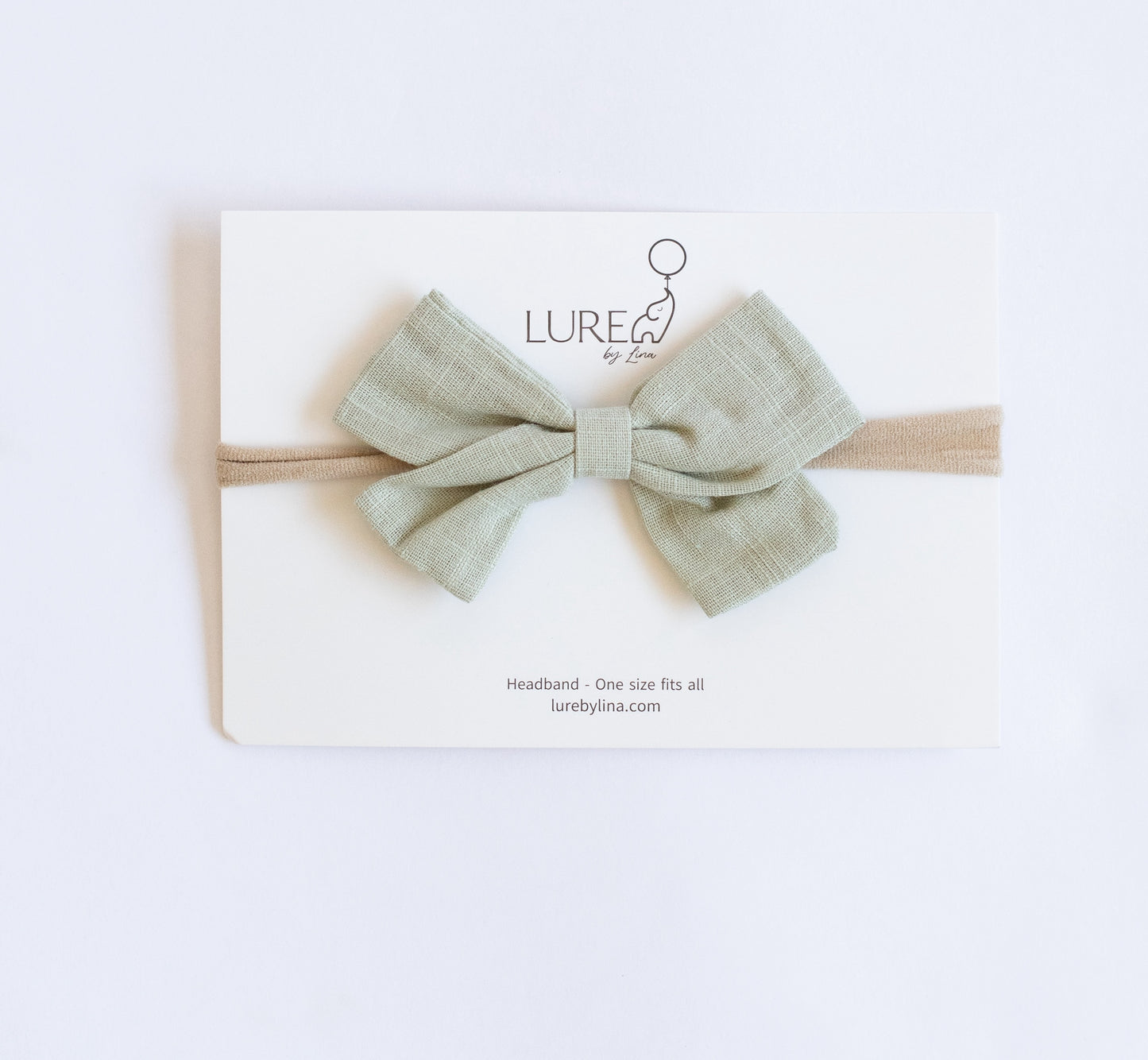 LURE by Lina Organic Cotton Bow in Pistachio — lightweight green baby bow made with organic cotton knit and water-based dyes
