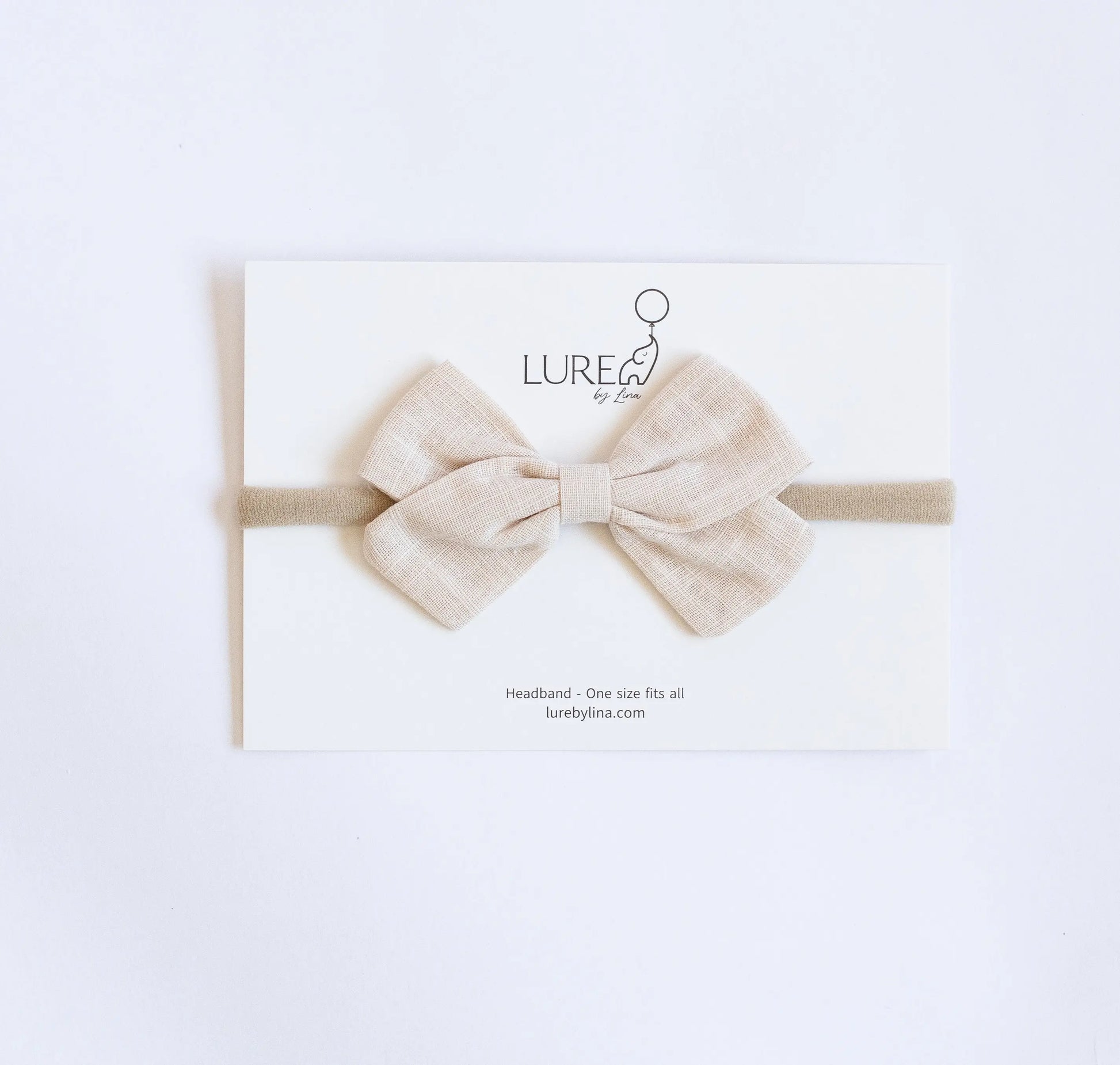 LURE by Lina Organic Cotton Bow in Sandstone — soft beige baby headband made from organic cotton knit and gentle nylon band