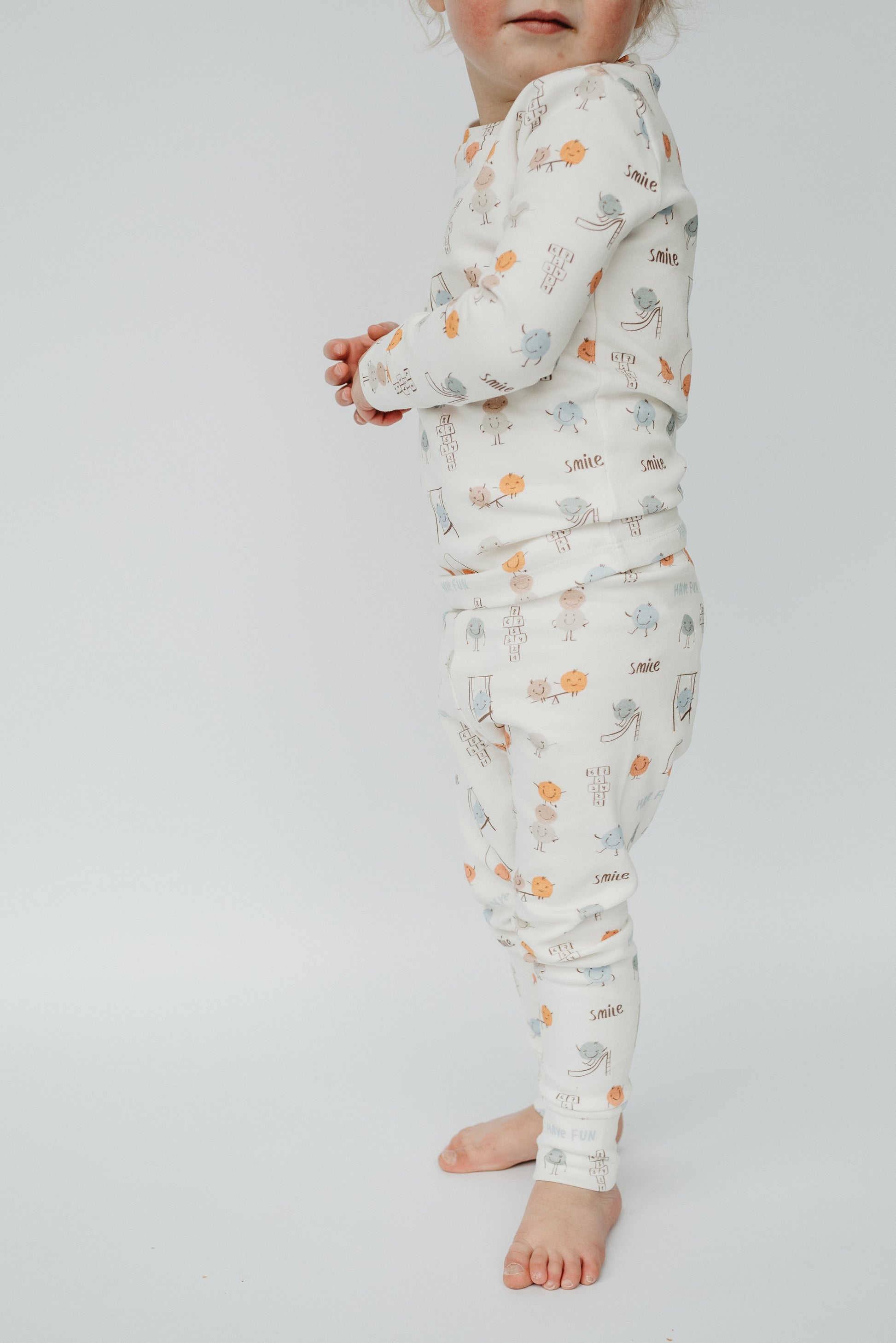 Close-up of LURE by Lina Play Time print cotton blend fabric — soft, stretchy material for baby and toddler pajamas