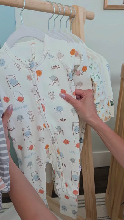 Matching baby and toddler pajamas in the Play Time print by LURE by Lina. Soft cotton blend, Diaper Peek-a-Boo zipper, and cozy comfort for all ages.